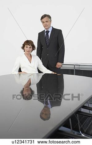 Two business colleagues at conference table, portrait View Large Photo Image Stock Image - Two business colleagues at conference table, portrait. Fotosearch