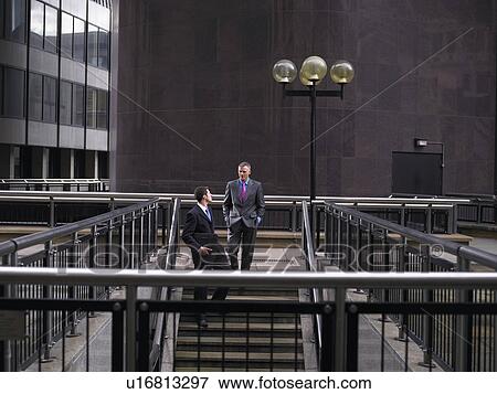 Stock Photo - Two business men descending steps. Fotosearch
