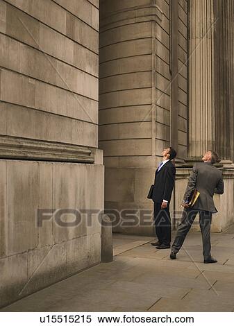 Stock Photography - Two businessmen facing monumental building. Fotosearch