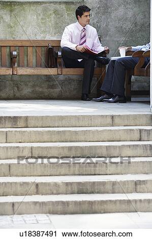 Stock Image - Two businessmen in outdoor meeting. Fotosearch