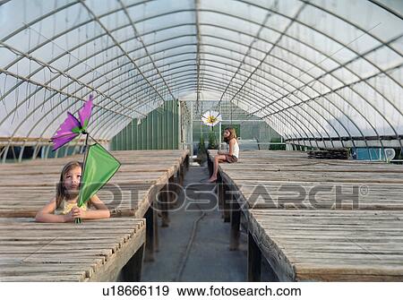 Two Little Girls in an Empty Greenhouse View Large Photo Image Stock Photo - Two Little Girls in an Empty Greenhouse. Fotosearch