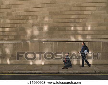 Two men on sidewalk, looking up View Large Photo Image Stock Image - Two men on sidewalk, looking up. Fotosearch