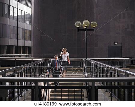 Stock Photo - Two people descending steps. Fotosearch