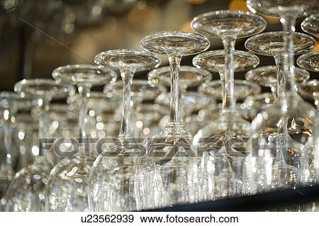 Stock Photo - Wine glasses in row on bar counter, close-up. Fotosearch