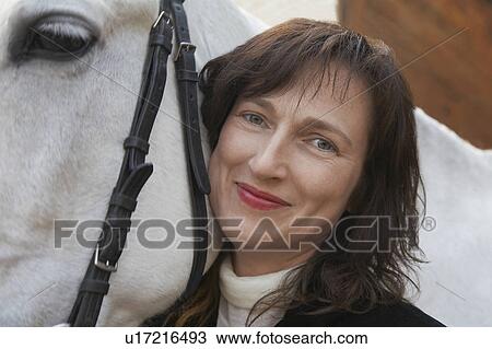 Stock Image - Woman and Her Horse. Fotosearch