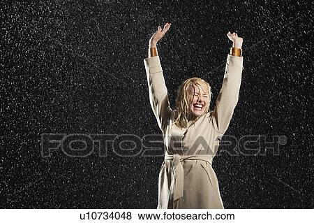 Woman, arms outstretched, smiling, standing in rain View Large Photo Image Stock Photo - Woman, arms outstretched, smiling, standing in rain. Fotosearch