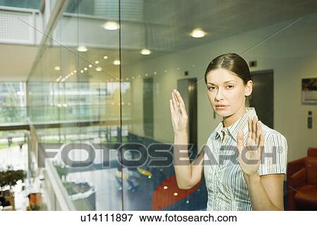 Woman Behind Glass Wall in office, portrait View Large Photo Image Stock Photo - Woman Behind Glass Wall in office, portrait. Fotosearch