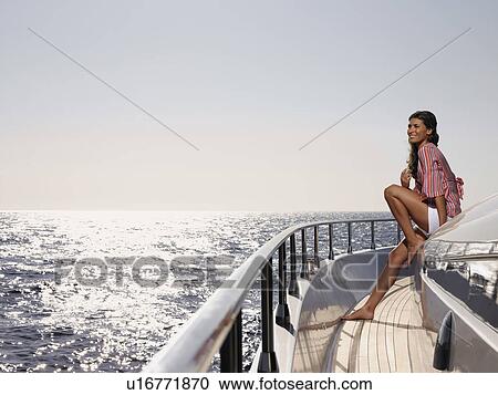 Stock Image - Woman on Deck of Boat. Fotosearch