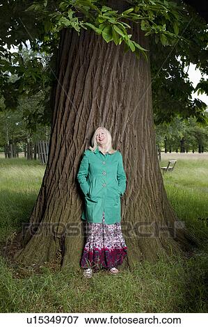 Woman Standing Beneath a Tree View Large Photo Image Stock Photo - Woman Standing Beneath a Tree. Fotosearch