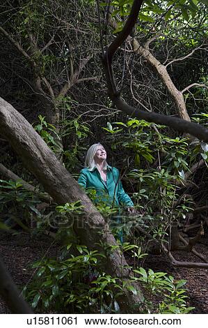 Stock Image - Woman Standing in the Woods. Fotosearch