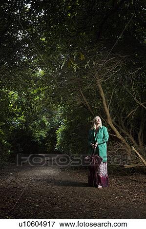 Woman Standing on a Forest Path View Large Photo Image Stock Photo - Woman Standing on a Forest Path. Fotosearch