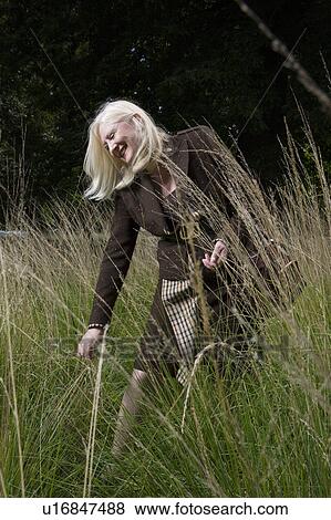Stock Photo - Woman Walking in a Meadow. Fotosearch