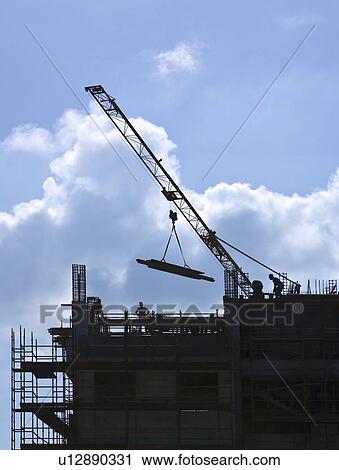 Workmen with crane on construction site, Nicosia, Cyprus View Large Photo Image Stock Image - Workmen with crane on construction site, Nicosia, Cyprus. Fotosearch