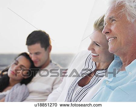 Young and middle-aged couple relaxing on yacht, focus on middle-aged couple View Large Photo Image Stock Image - Young and middle-aged couple relaxing on yacht, focus on middle-aged couple. Fotosearch