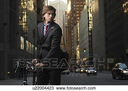 Young Businessman Bicycling to Work View Large Photo Image Stock Image - Young Businessman Bicycling to Work. Fotosearch