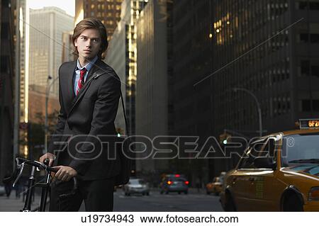 Stock Image - Young Businessman with Bicycle. Fotosearch
