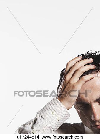 Young Businessman with Hand on Head, close-up View Large Photo Image Picture - Young Businessman with Hand on Head, close-up. Fotosearch