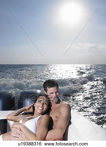 Young couple on speedboat View Large Photo Image Stock Photograph - Young couple on speedboat. Fotosearch
