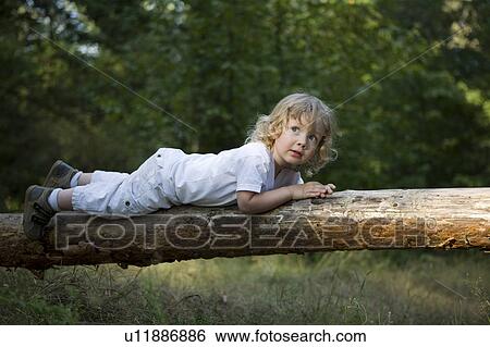 Young Girl Lying On Tree Trunk View Large Photo Image Stock Photograph - Young Girl Lying On Tree Trunk. Fotosearch