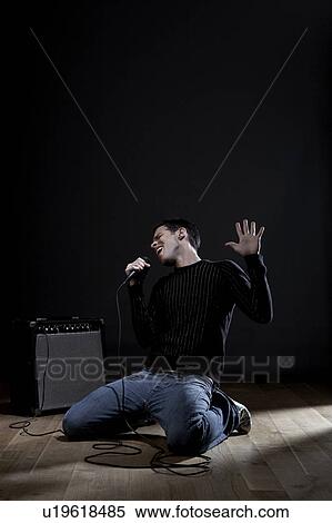 Young man singing on stage View Large Photo Image Stock Photography - Young man singing on stage. Fotosearch