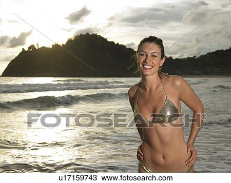 Young Woman at Beach at Sunset View Large Photo Image Stock Image - Young Woman at Beach at Sunset. Fotosearch