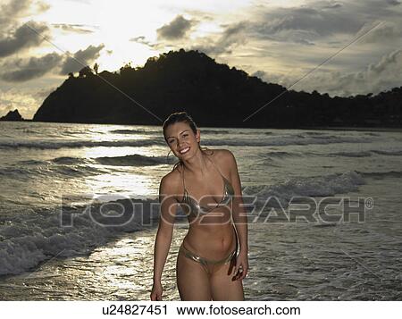 Young Woman at Beach at Sunset View Large Photo Image Stock Image - Young Woman at Beach at Sunset. Fotosearch