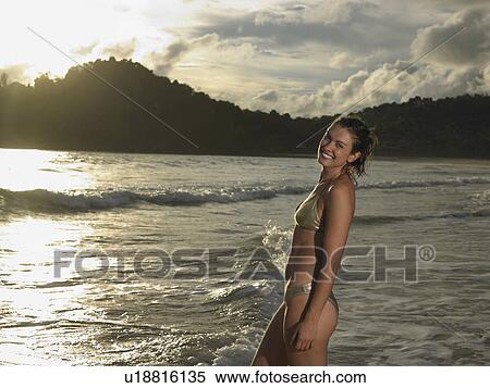 Stock Photography - Young Woman at Beach at Sunset. Fotosearch