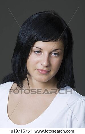 Stock Image - Young woman daydreaming. Fotosearch