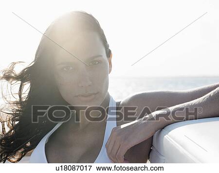Stock Photo - Young woman in bikini against sea. Fotosearch