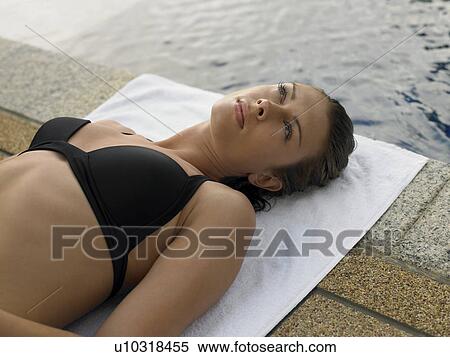 Stock Photography - Young Woman in Bikini by Swimming Pool. Fotosearch