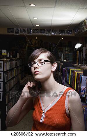 Young woman in library, portrait View Large Photo Image Stock Image - Young woman in library, portrait. Fotosearch