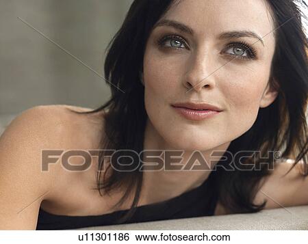Young woman indoors, close-up View Large Photo Image Stock Photograph - Young woman indoors, close-up. Fotosearch