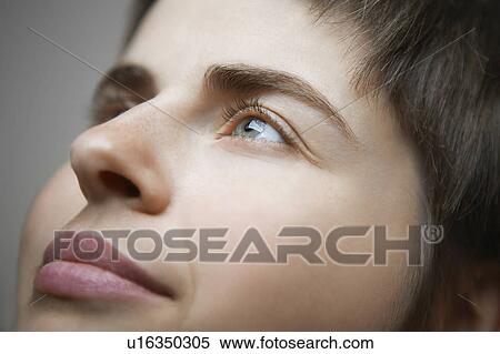 Stock Photography - Young Woman Looking Up. Fotosearch