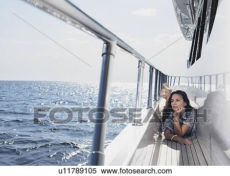 Young woman lying on deck of yacht View Large Photo Image Stock Photography - Young woman lying on deck of yacht. Fotosearch