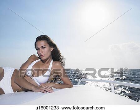Young woman lying on yacht View Large Photo Image Stock Image - Young woman lying on yacht. Fotosearch