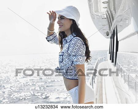 Picture - Young woman on yacht, side view. Fotosearch