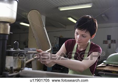 Young woman operating printing press View Large Photo Image Stock Photography - Young woman operating printing press. Fotosearch