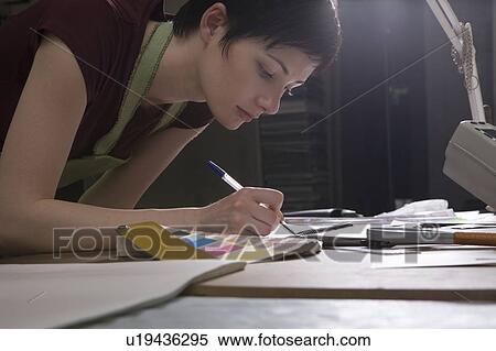 Young woman operating printing press View Large Photo Image Stock Photography - Young woman operating printing press. Fotosearch