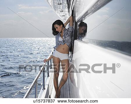 Stock Photo - Young woman posing on yacht. Fotosearch