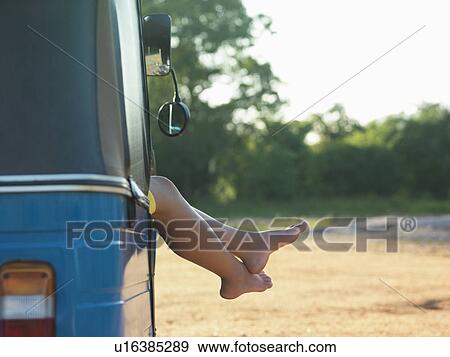Young woman resting in vehicle, legs visible View Large Photo Image Stock Photo - Young woman resting in vehicle, legs visible. Fotosearch
