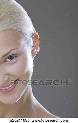Young woman smiling, headshot, cropped View Large Photo Image Stock Photography - Young woman smiling, headshot, cropped. Fotosearch