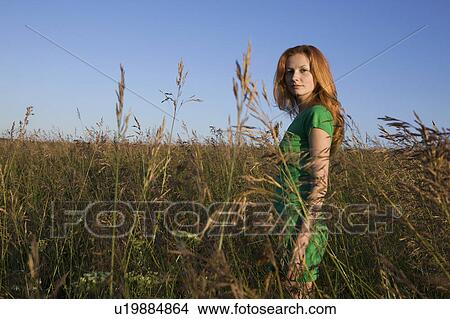 Young Woman Standing in a Field View Large Photo Image Picture - Young Woman Standing in a Field. Fotosearch