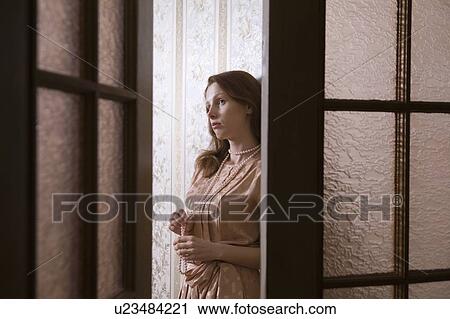 Stock Image - Young woman through glass panelled doors of Russian apartment. Fotosearch
