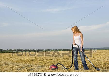 Young Woman Vacuuming a Field View Large Photo Image Stock Photo - Young Woman Vacuuming a Field. Fotosearch