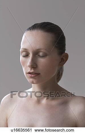 Stock Image - Young woman with eyes closed. Fotosearch