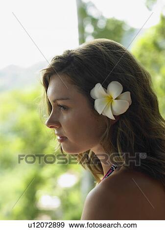 Stock Photo - Young Woman with Flower in Hair. Fotosearch