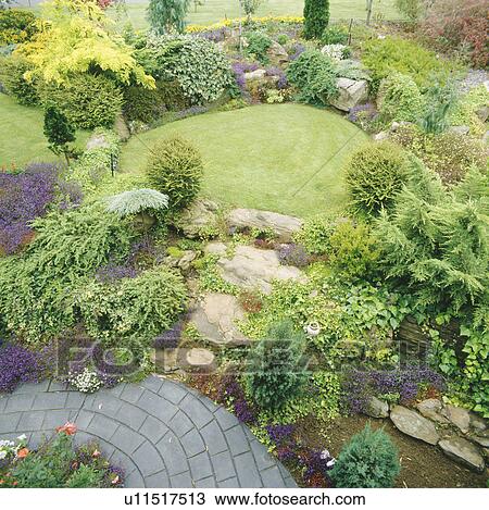 Aerial view of well-mainted garden with rock steps through rockery border to sunken circular lawn View Large Photo Image Stock Image - Aerial view of well-mainted garden with rock steps through rockery border to sunken circular lawn. Fotosearch