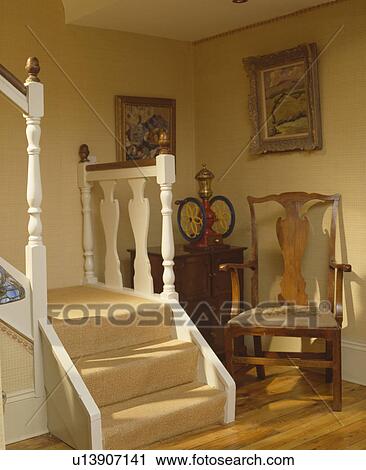 Antique chair in corner of neutral hall with cream carpet on the stairs View Large Photo Image Stock Image - Antique chair in corner of neutral hall with cream carpet on the stairs. Fotosearch