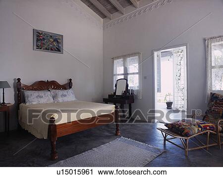 Antique mahogany bed in Caribbean bedroom with door open to veranda View Large Photo Image Stock Image - Antique mahogany bed in Caribbean bedroom with door open to veranda. Fotosearch