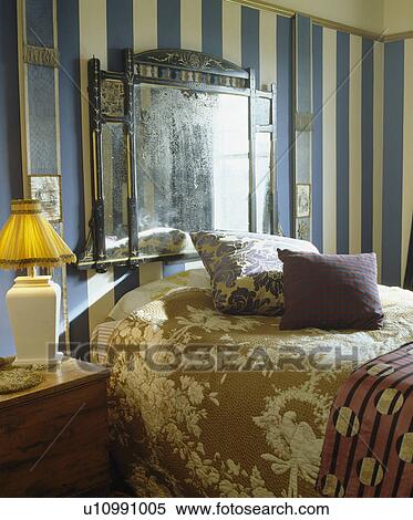 Antique overmantel mirror above bed with beige patterned bedlinen View Large Photo Image Stock Photography - Antique overmantel mirror above bed with beige patterned bedlinen. Fotosearch